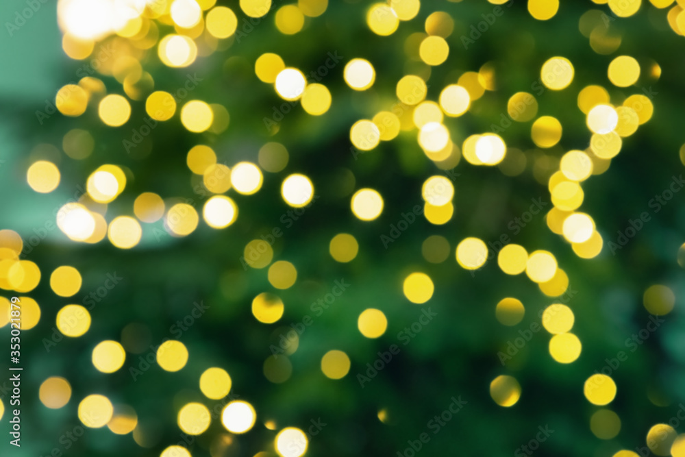 Christmas tree lights. Bokeh abstract texture. New Year background with bright yellow glitters. Christmas tree lights. Bokeh abstract texture. New Year background with bright yellow glitters.