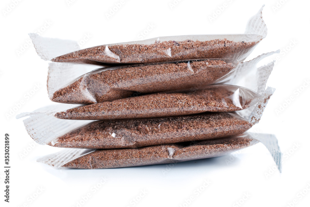 Flax porridge in a transparent plastic bags isolated on a white background. Flax porridge in a transparent plastic bags isolated on a white background.
