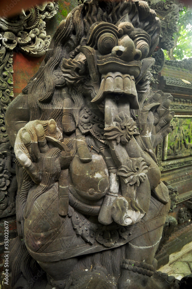 Art sculpture and carved antique deity angel god of hindu statue balinese style in Mandala Suci Wenara Wana or Ubud Sacred Monkey Forest Sanctuary at Ubud city in Bali, Indonesia