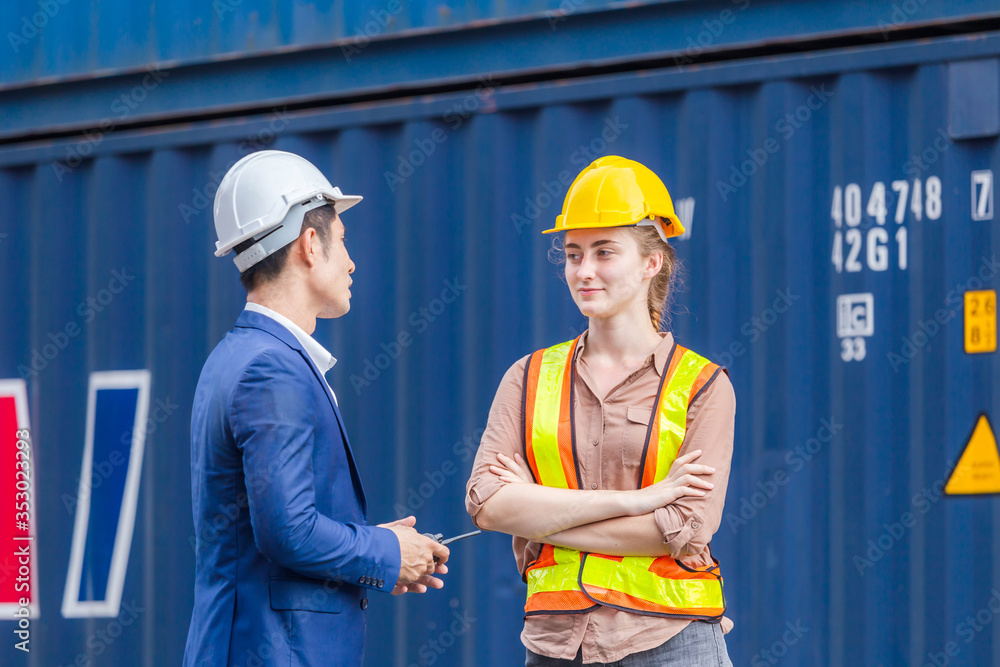 Engineer and foreman worker team checking containers box from cargo, Logistic and teamwork concept Engineer and foreman worker team checking containers box from cargo, Logistic and teamwork concept