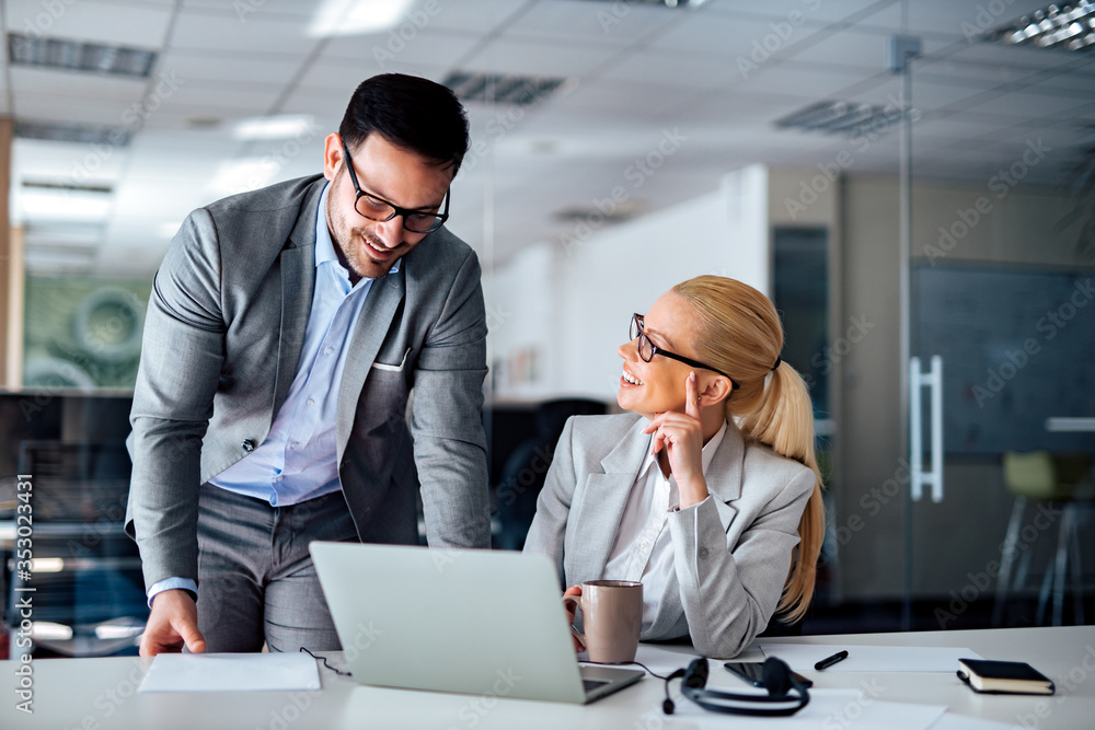 Portrait of a charming business partners at work, smiling and talking about business. Portrait of a charming business partners at work, smiling and talking about business.