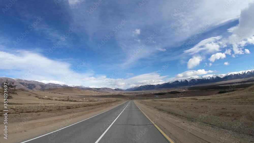 Driving along mountain road Chuysky Tract along Kurai Ridge on Altai at Spring season Driving along mountain road Chuysky Tract along Kurai Ridge on Altai at Spring season