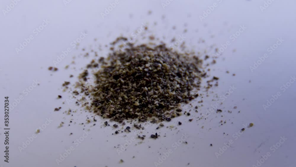 Macro shot of black pepper being poured in slow motion, 180fps Macro shot of black pepper being poured in slow motion, 180fps
