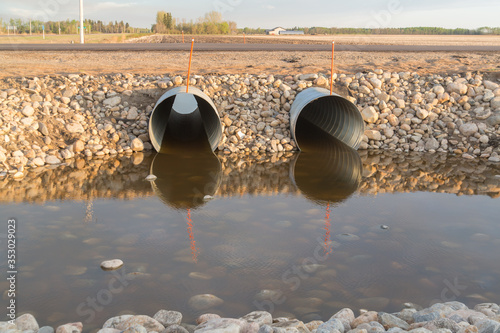 Slika na platnu steel culverts and rocks alongside a highway