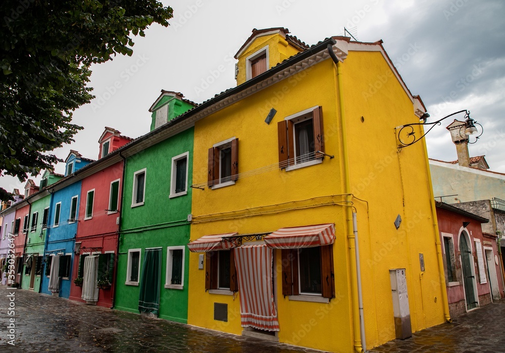 colorful houses in Burano island near Venice in a cloudy day, Italy