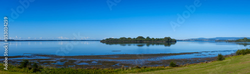 panoramic early morning view of island and reflections across Lake Illawarra  New South Wales  NSW  Australia