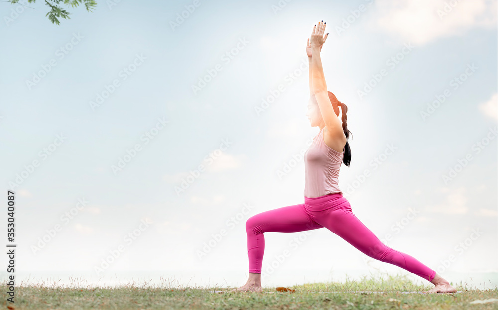 Fototapeta premium Young beautiful asian woman doing yoga practice on park.