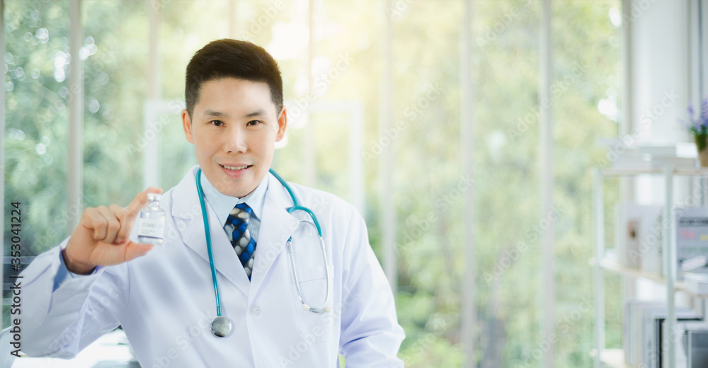 Professional Asian doctor portrait wearing stethoscope medical and holding vaccine liquid bottle in modern office with green bokeh background. Copy space available Professional Asian doctor portrait wearing stethoscope medical and holding vaccine liquid bottle in modern office with green bokeh background. Copy space available