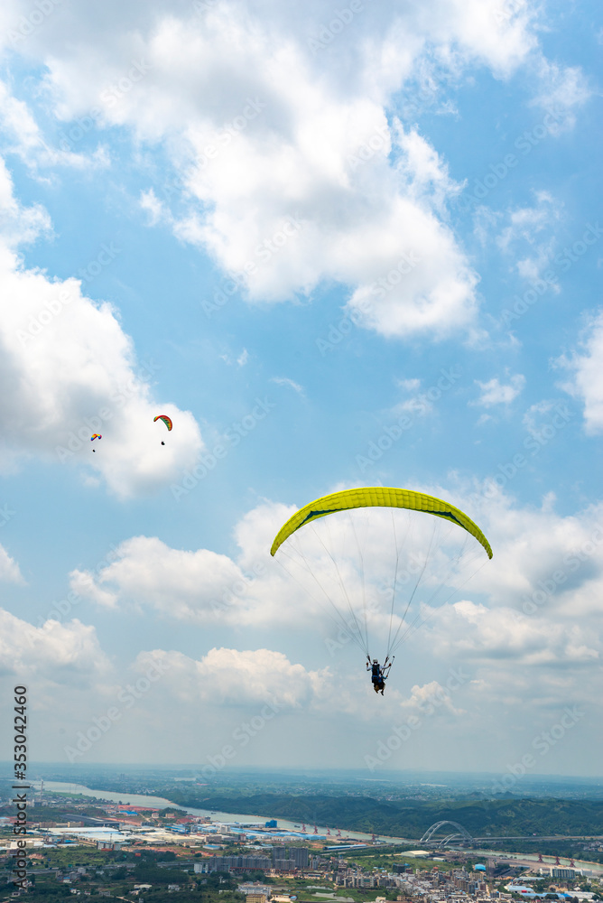 Outdoor city green hill scenery and paragliding Outdoor city green hill scenery and paragliding