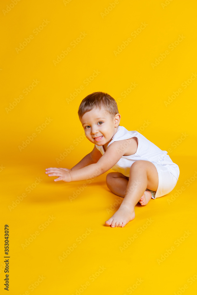 baby boy squats and stretches his hand forward baby boy squats and stretches his hand forward