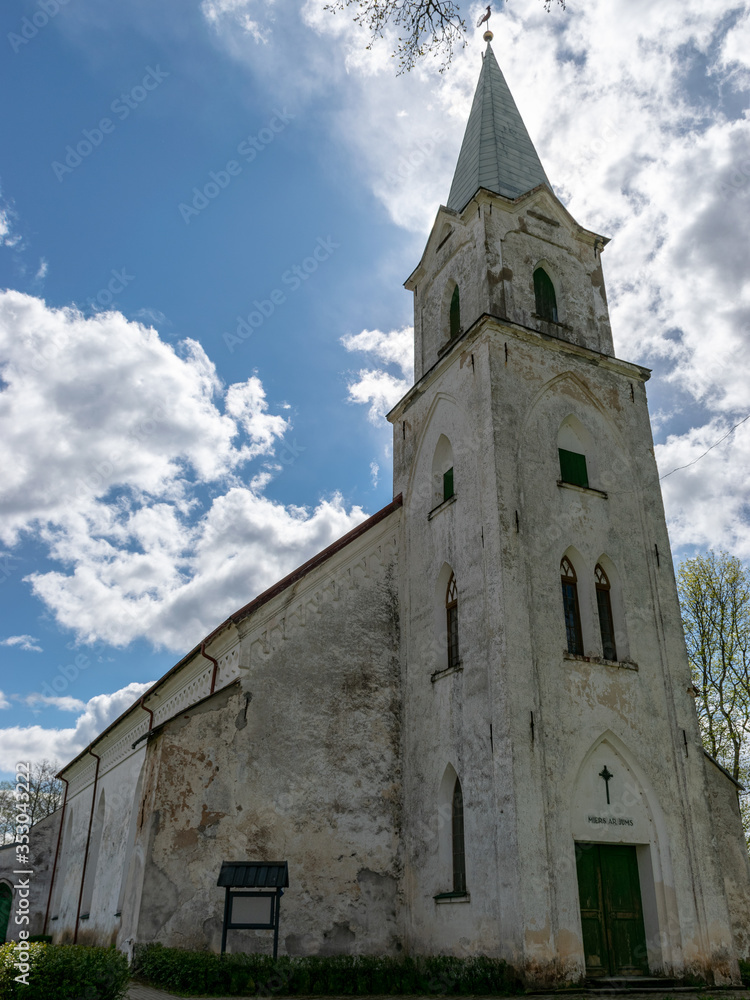 Fototapeta premium a white Lutheran church tower against the sky