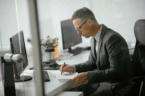 Handsome businessman working in office. Young man preparing for the meeting.	