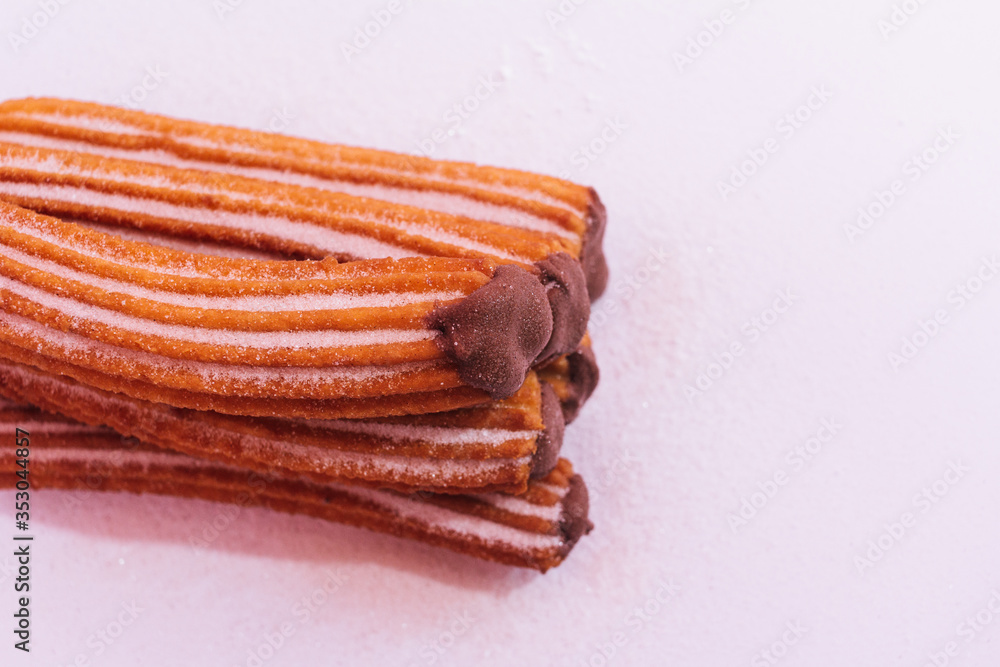 Churros stuffed with chocolate sauce on white background Churros stuffed with chocolate sauce on white background