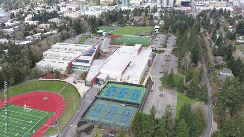 Aerial / drone footage of Bellevue Highschool, closed early due to the pandemic, with empty streets, no cars or people in Belleview, a suburb of Seattle, Washington photo
