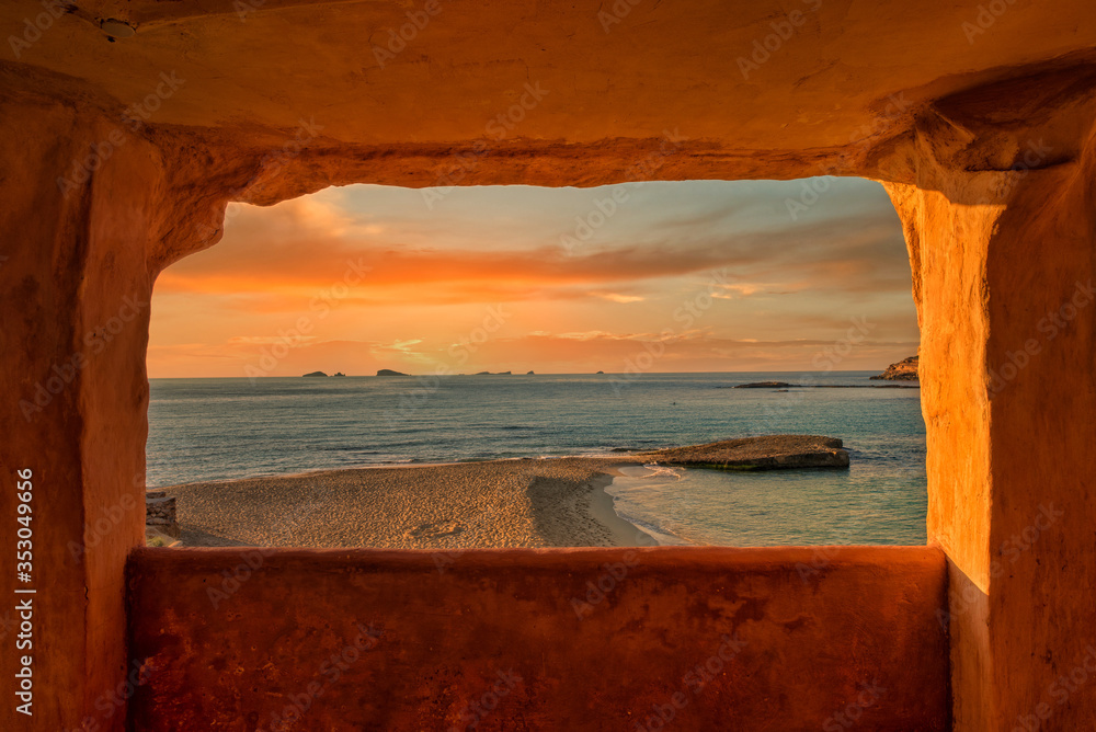 Window to Cala Comte de Ibiza at sunset