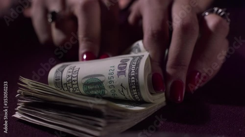 counting one hundred dollar bills in slow motion and dropping dollars