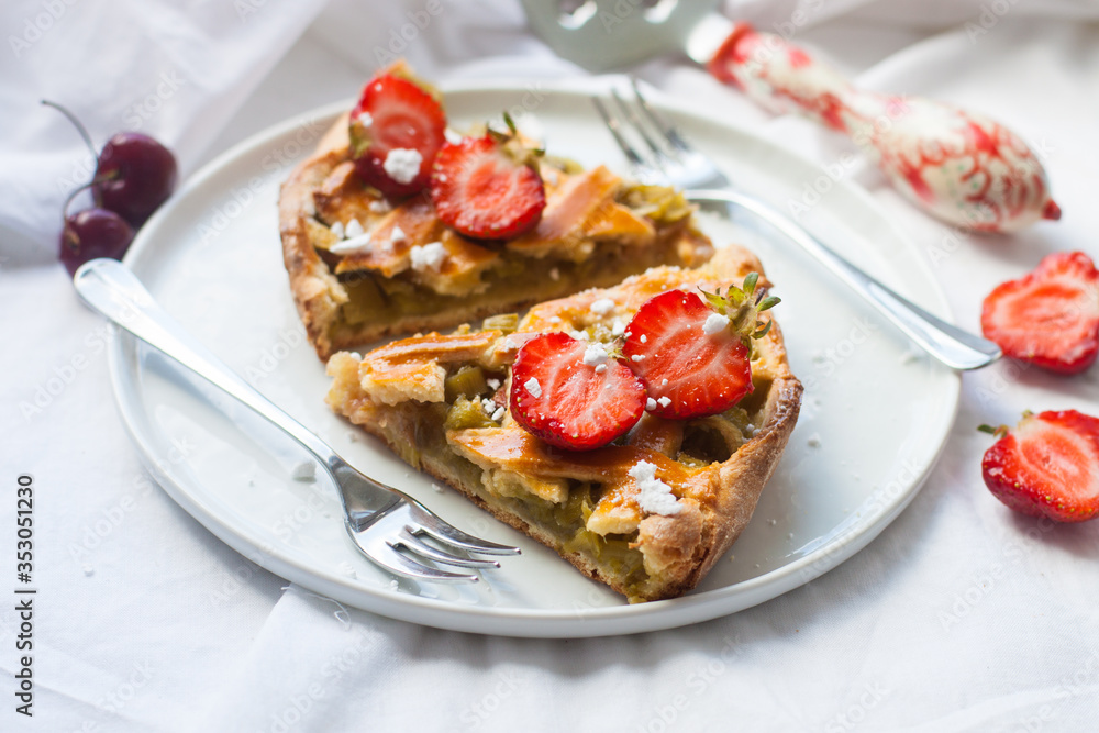 Slices of strawberry and rhubarb pie on white plate. Top view. Homemade summer bakery. Slices of strawberry and rhubarb pie on white plate. Top view. Homemade summer bakery.