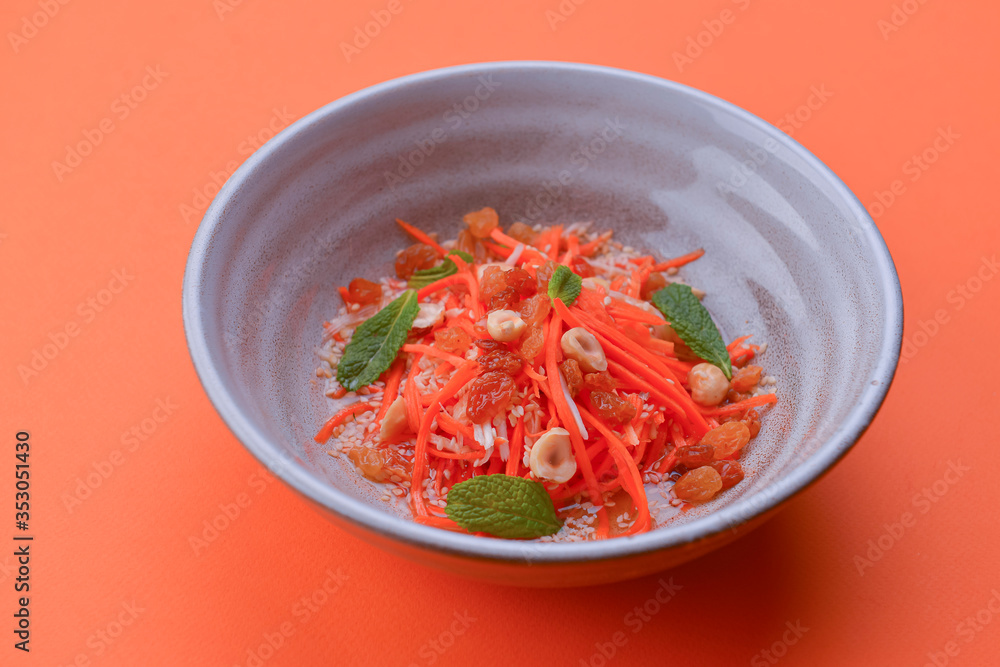 Fresh carrot salad with shredded carrots, raisins, sesame seeds and a light dressing. Served in a white bowl. Fresh carrot salad with shredded carrots, raisins, sesame seeds and a light dressing. Served in a white bowl.
