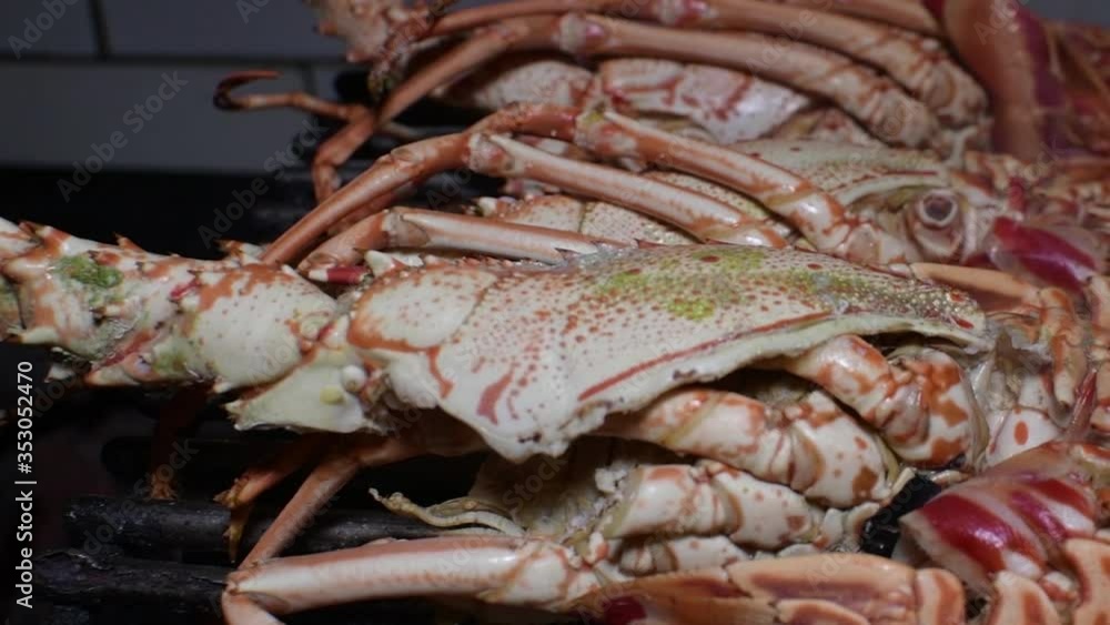 Whole Lobsters cooking on the grill in the restaurant kitchen close up. Panng right. Food Photography Whole Lobsters cooking on the grill in the restaurant kitchen close up. Panng right. Food Photography