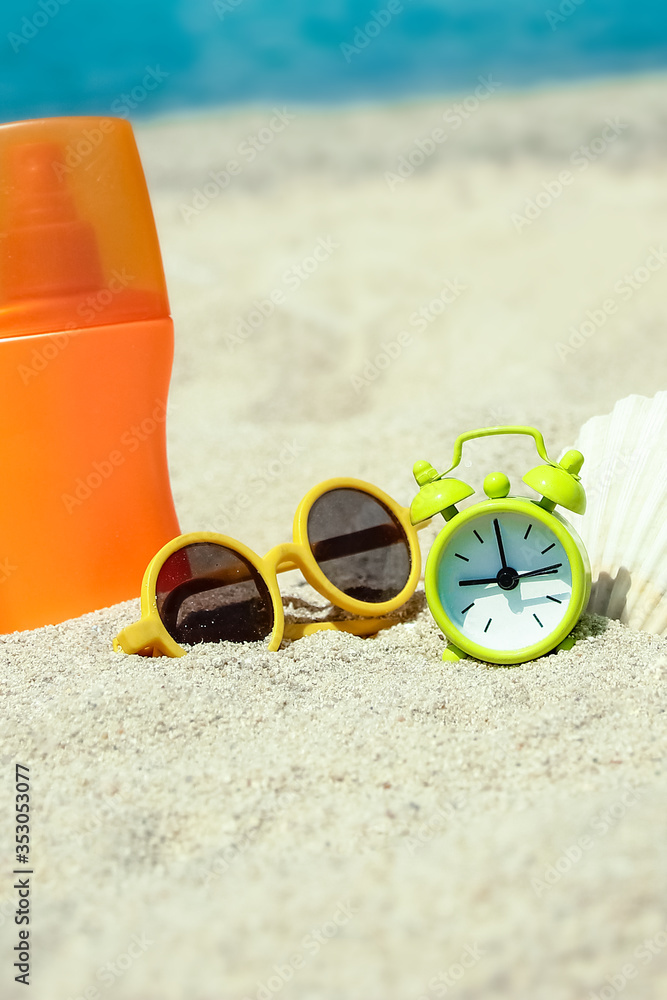 beautiful alarm clock in the sand by the sea on nature background beautiful alarm clock in the sand by the sea on nature background