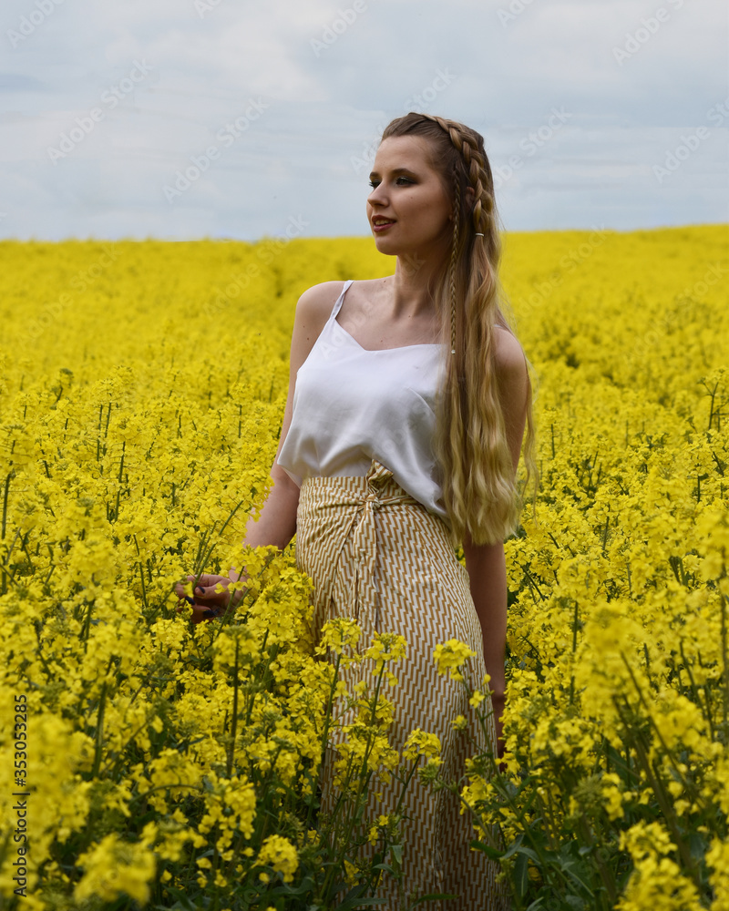Fototapeta premium young woman in rape field