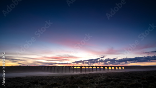 A misty sunrise over the iconic landmark Ribblehead Viaduct in the yorkshire dales national park,yorkshire, england