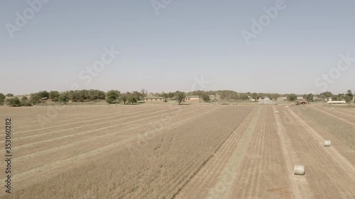 Drone shot flying over and down onto a dry soybean field in winter before harvesting photo