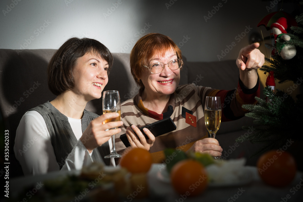 Women watching tv while celebrating New Year