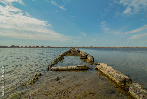 Salt lake in a sea resort. A path in the water that leads to the bird s habitat.