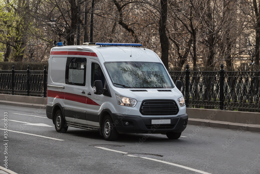 Ambulance car moves along a city street