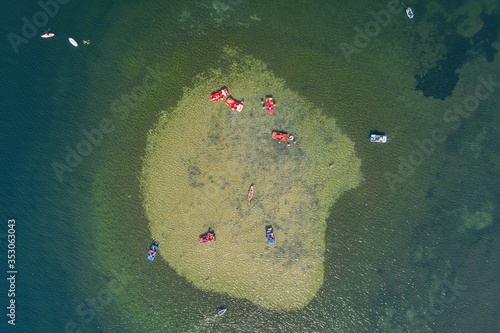 Holiday vacation on the sandy beach, water bike, kayak in the atoll lagoon water photo