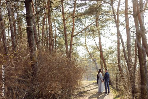 Happy pregnant couple in nature