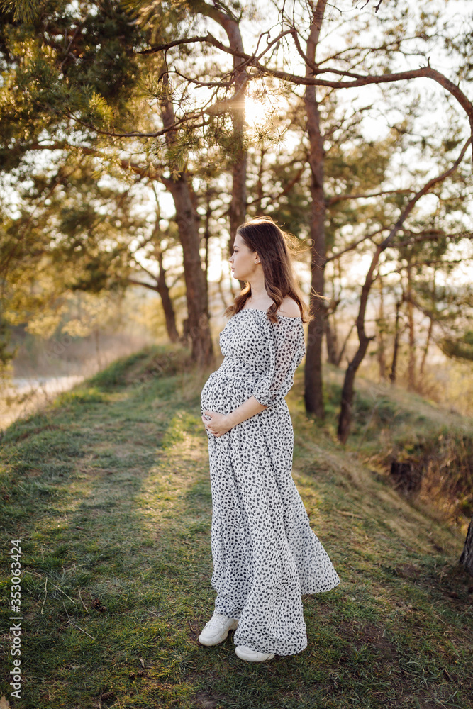 Young pregnant woman relaxing in park outdoors Young pregnant woman relaxing in park outdoors