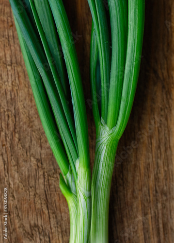 Green onions on a wooden background. Onions on old wood.