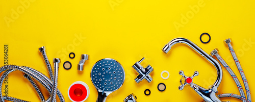 фотографія Set of plumbing for bathroom or shower on an yellow background