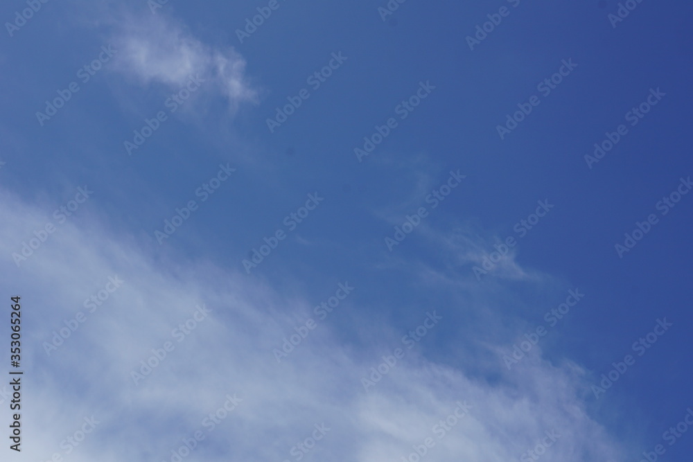 Fluffy white clouds in daytime blue sky background Fluffy white clouds in daytime blue sky background