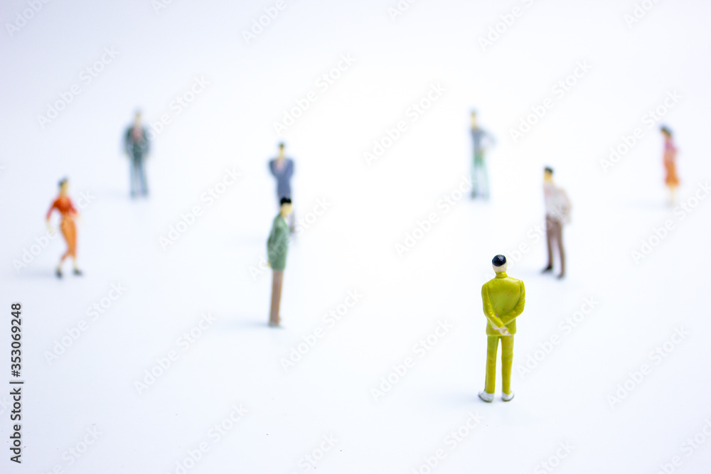 miniature businessmen keep distance away in the public. Social distancing concept avoid COVID-19 coronavirus spreading. miniature businessmen keep distance away in the public. Social distancing concept avoid COVID-19 coronavirus spreading.