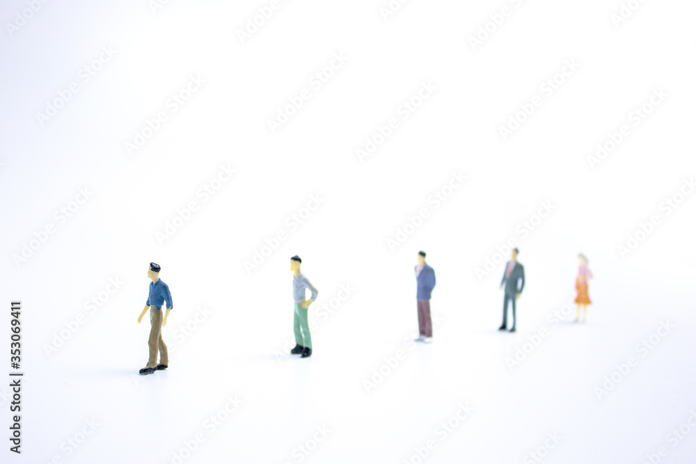 miniature businessmen keep distance away in the public. Social distancing concept avoid COVID-19 coronavirus spreading. miniature businessmen keep distance away in the public. Social distancing concept avoid COVID-19 coronavirus spreading.
