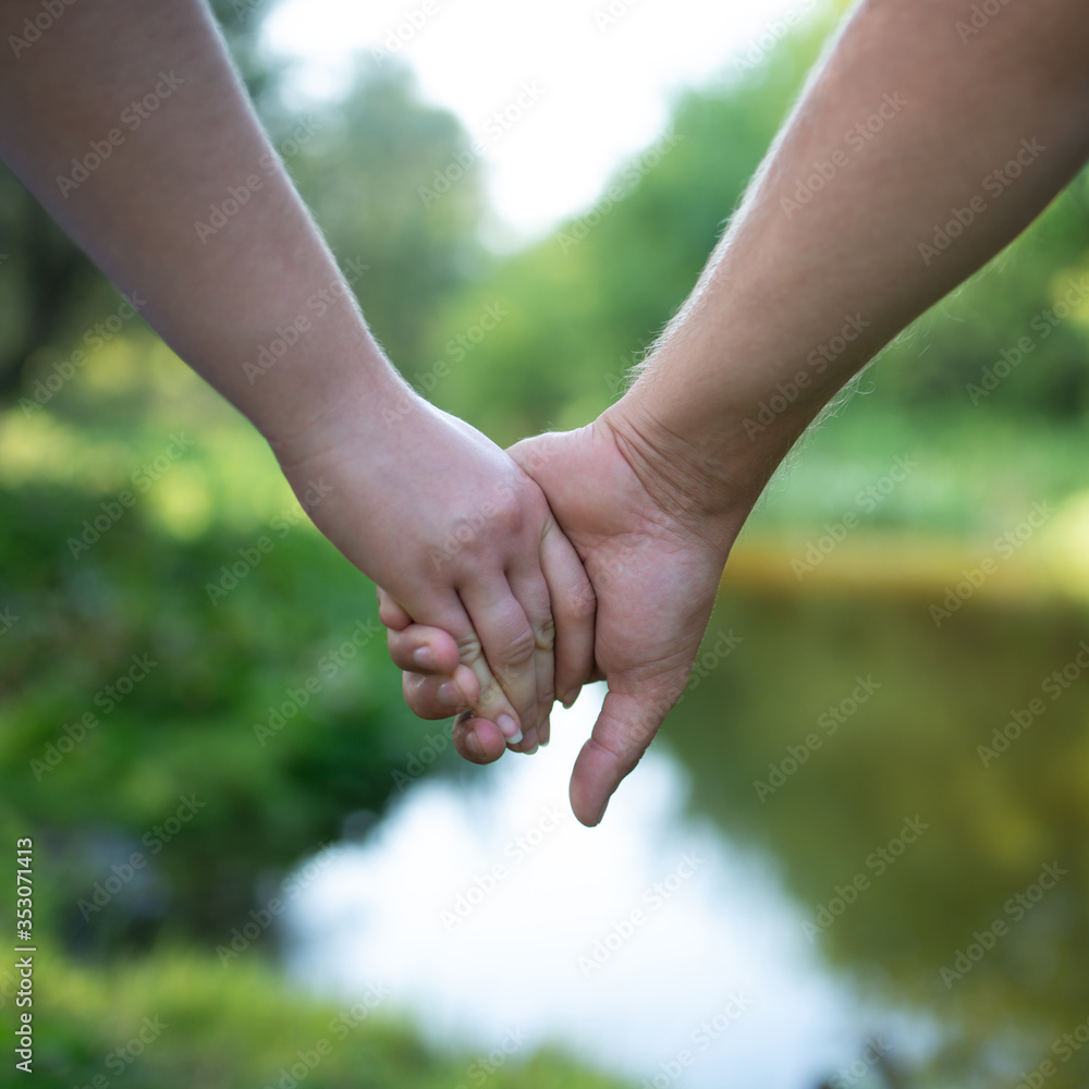 The hands of a couple in love The hands of a couple in love
