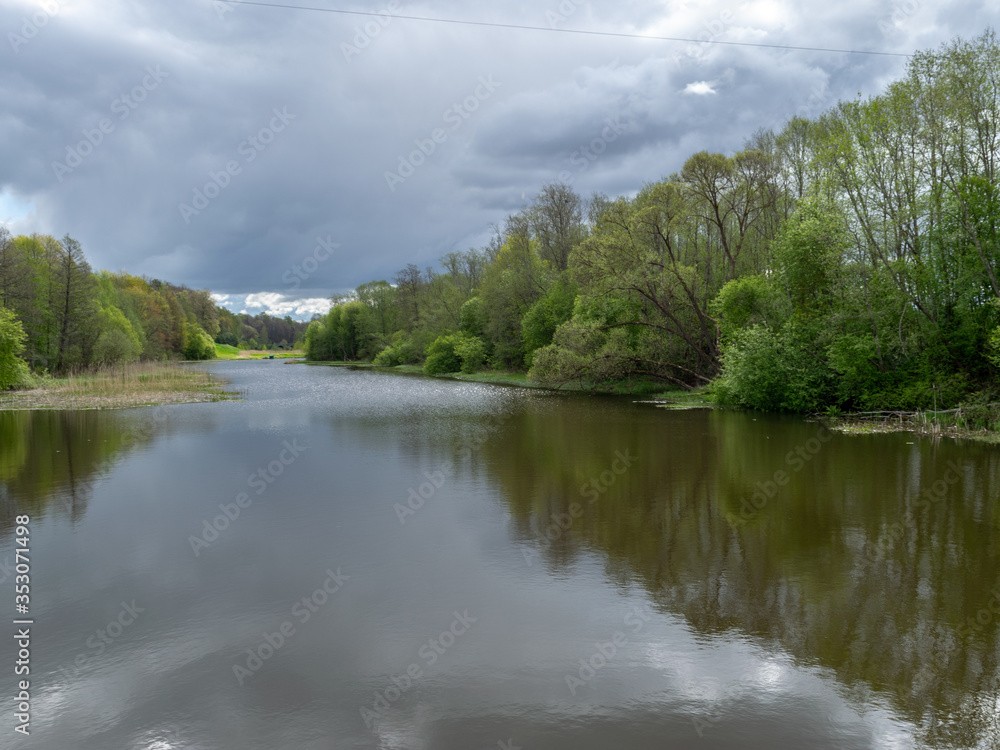 spring landscape with a river, the first bright spring greenery on the river bank