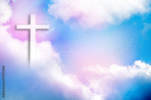 Christian cross appears bright in the sky background © byjeng