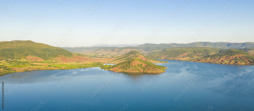 Aerial panorama of Lac du Salagou in the early morning in summer in Hérault in Occitania, France