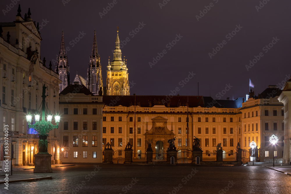 Main gate of the Prague Castle by night as seen from Hradcanske Namesti square. 