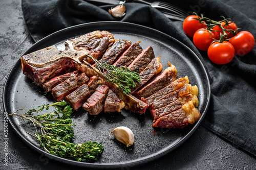 Grilled Porterhouse steak on a chopping Board. Cooked beef meat. White wooden background. Top view