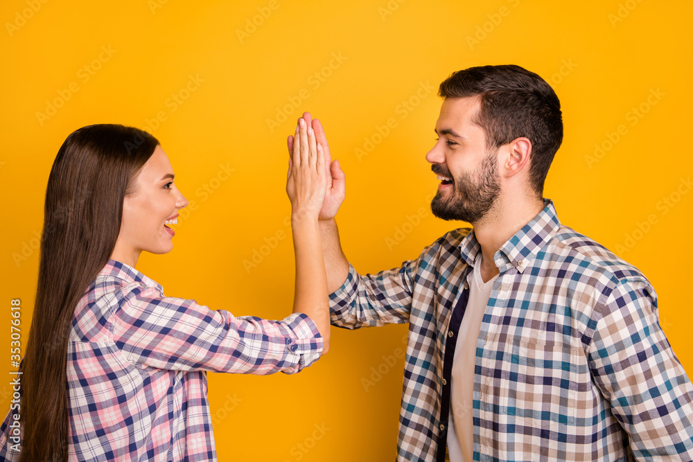 Profile side photo of excited spouses man woman take party sport match celebrate victory hold hand gesture high five wear good look outfit isolated over bright shine color background Profile side photo of excited spouses man woman take party sport match celebrate victory hold hand gesture high five wear good look outfit isolated over bright shine color background
