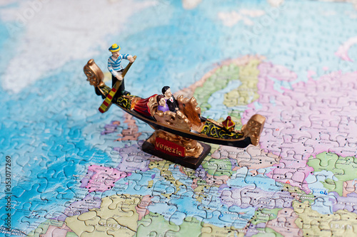 Tourist attractions and souvenir of gondola, venice, italy on background map of world of puzzles for travelers. Copy space