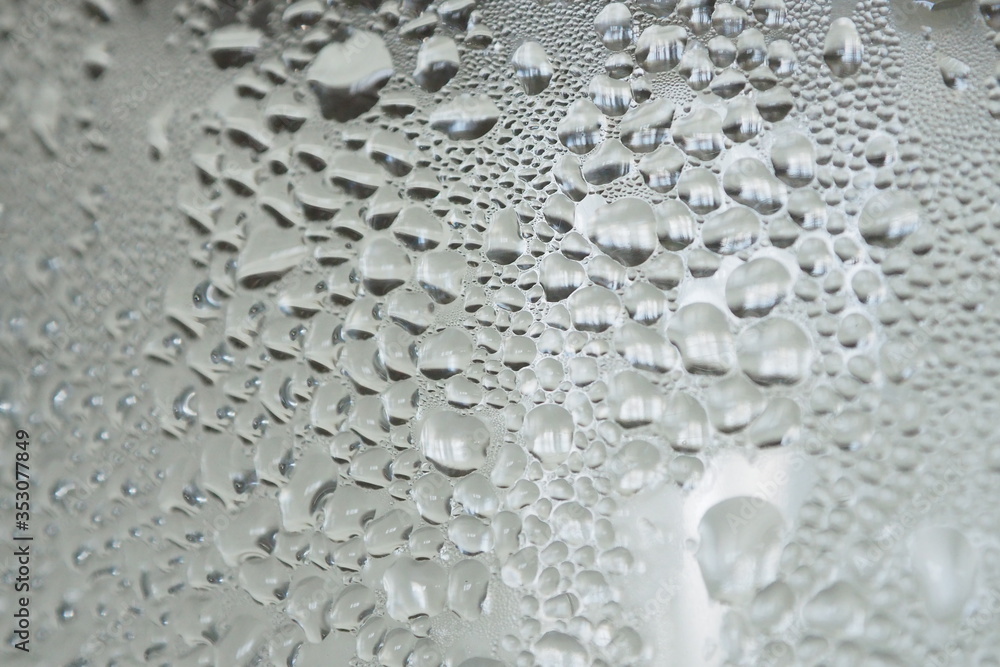 Closeup of beautiful water drops on a clear glass with ice and cold water inside Abstract blurred background and decoration Closeup of beautiful water drops on a clear glass with ice and cold water inside Abstract blurred background and decoration