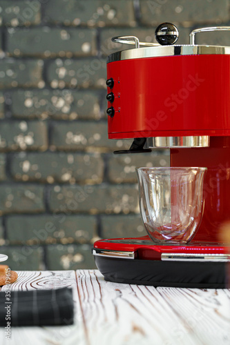 Red coffee machine with a glass on kitchen counter