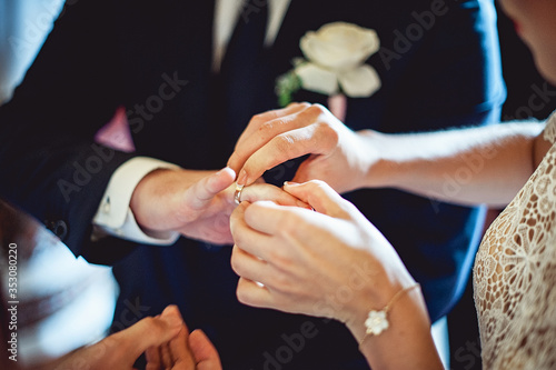 exchanging wedding rings. Bride puts a ring on the groom's finger