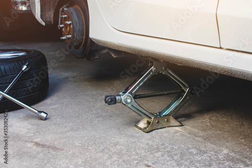 Wallpaper Mural Car jack for lifting tire emergency change and maintenance service. Torontodigital.ca